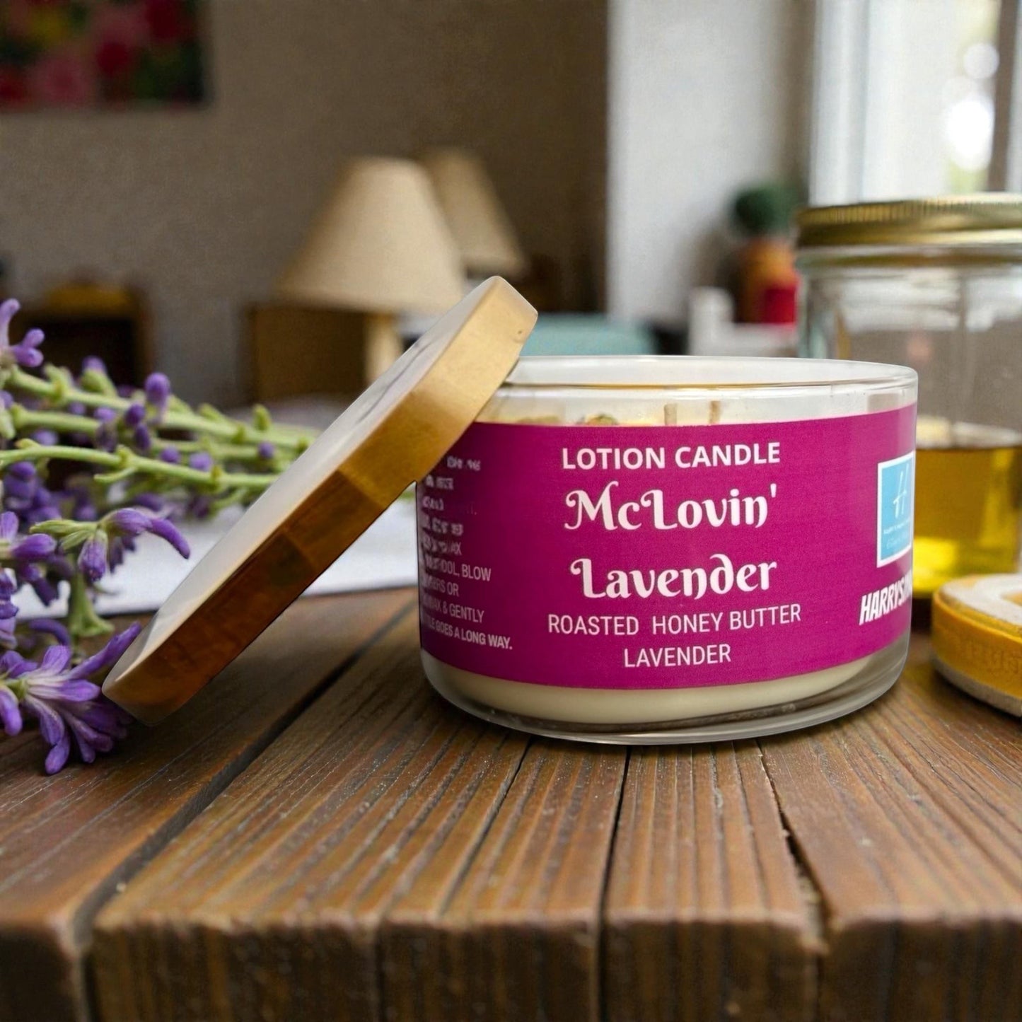 Harry’s Mama’s Faves: Lotions & Potions McLovin' Lavender lotion candle in a glass jar with a wooden lid and lavender.