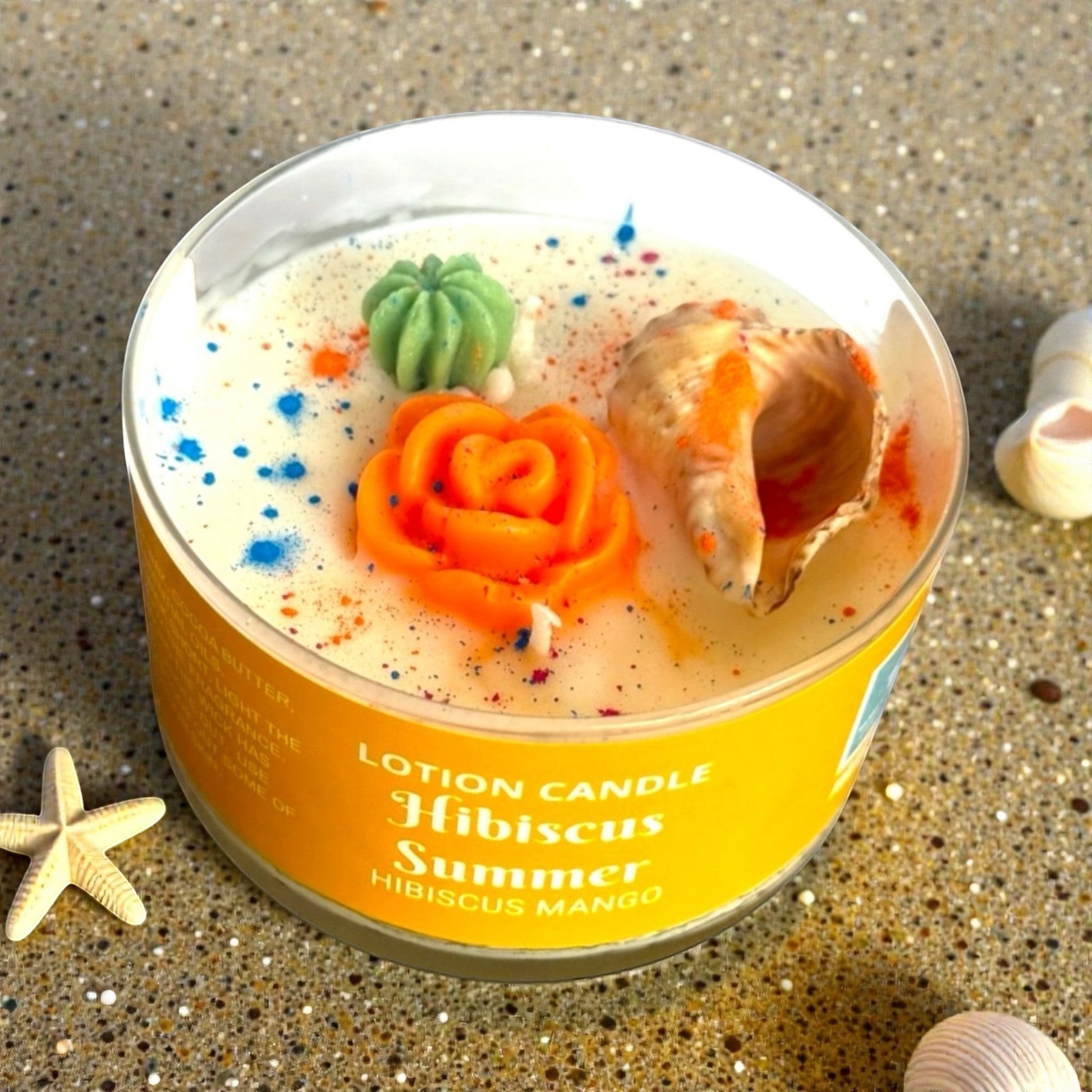 Harry’s Mama’s Faves: Lotions & Potions Hibiscus Summer lotion candle with decorative wax embeds and seashells.