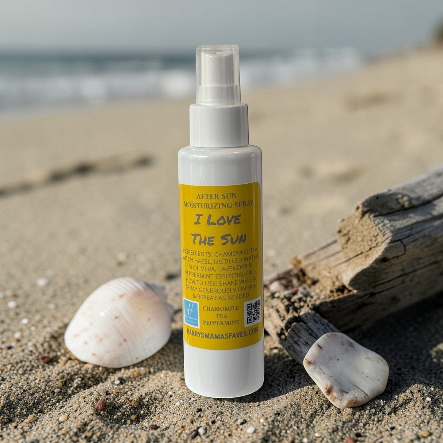 Harry’s Mama’s Faves: Lotions & Potions after sun moisturizer spray bottle on a sandy beach with seashells.