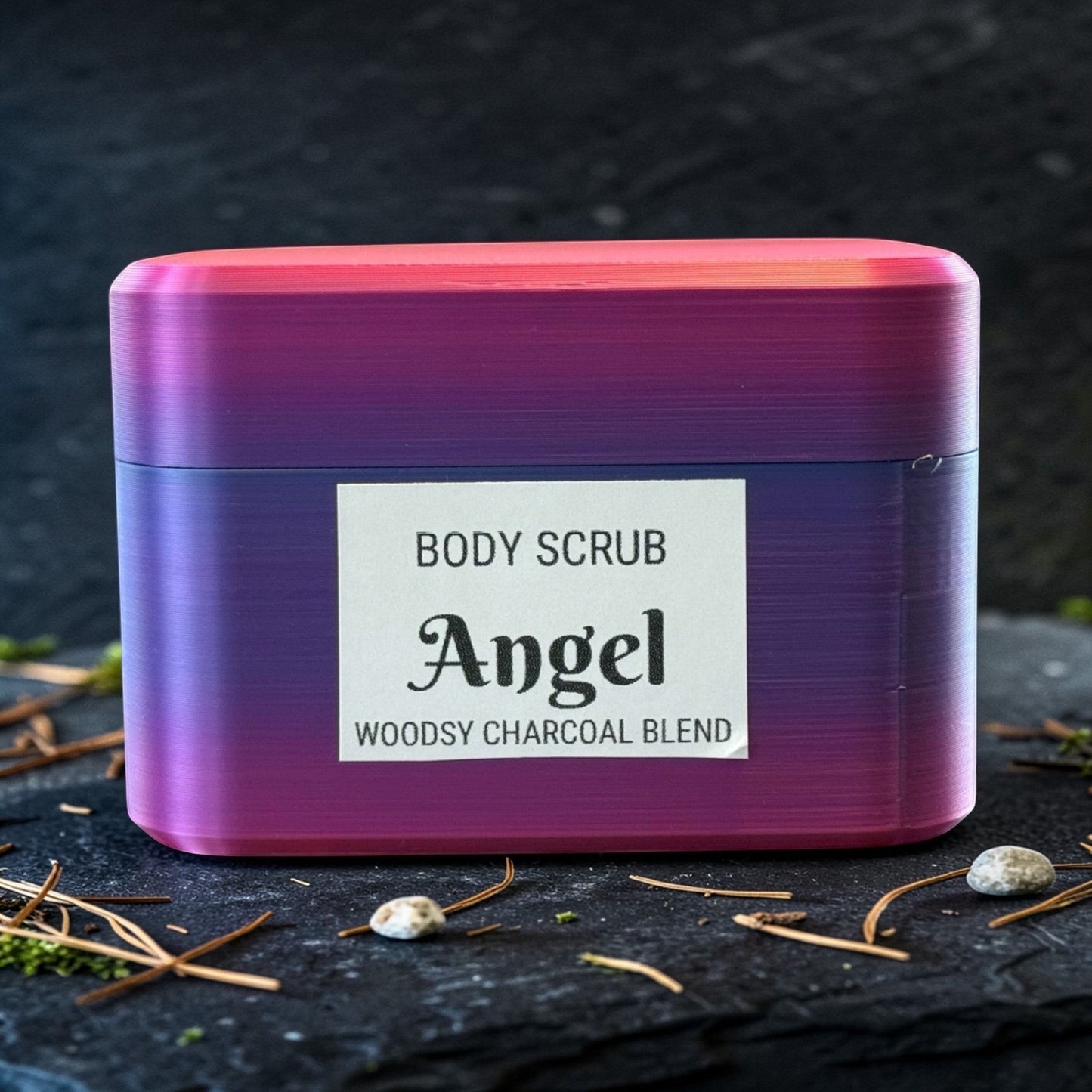 Harry’s Mama’s Faves: Lotions & Potions Angel body scrub in a purple and pink gradient container on a dark surface.