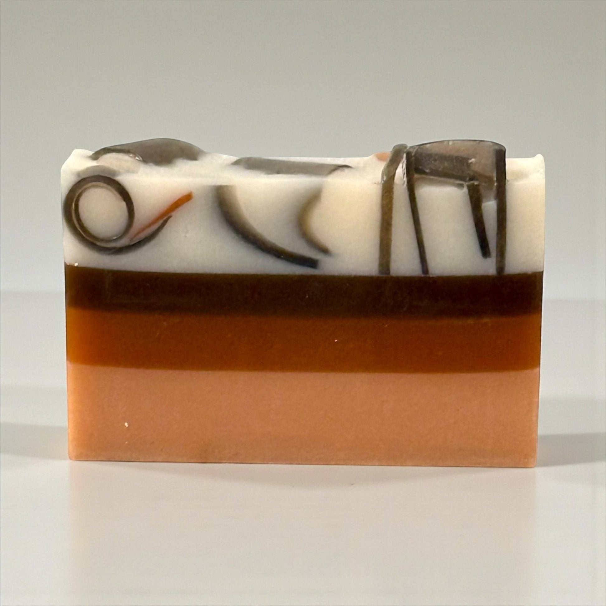 Harry’s Mama’s Faves: Lotions & Potions Hawaiian Coconut artisan handmade bar soap with layered orange and brown tones.