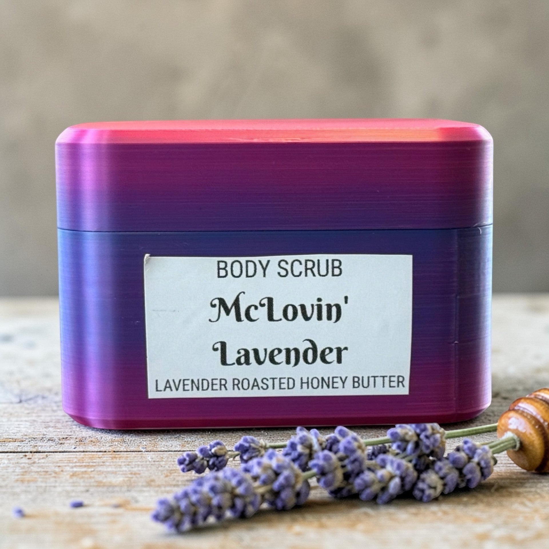 Harry’s Mama’s Faves: Lotions & Potions body scrub in a purple and pink gradient container with lavender sprigs.