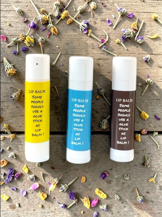Harry’s Mama’s Faves: Lotions & Potions moisturizing lip balm trio in yellow, blue, and brown glue stick tubes.