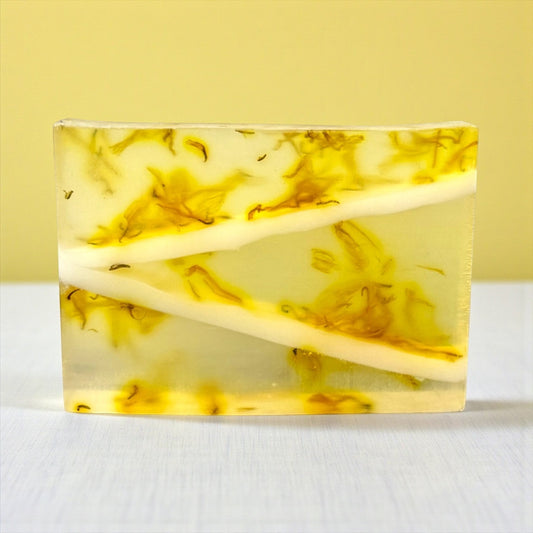 Harry’s Mama’s Faves: Lotions & Potions Pink Daisies artisan handmade bar soap with yellow floral inclusions.