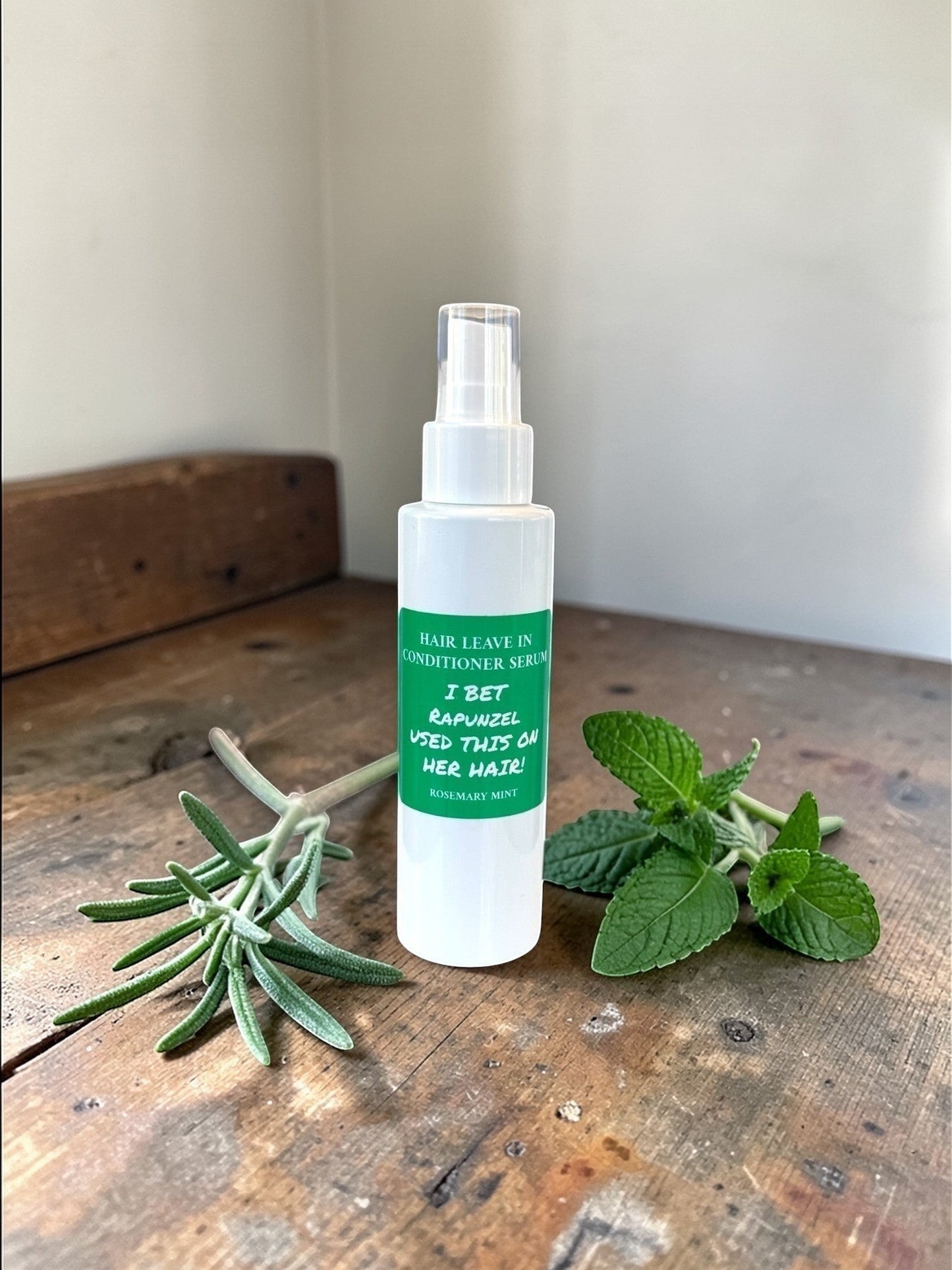 Harry’s Mama’s Faves: Lotions & Potions rosemary mint leave-in hair conditioner spray in a 4 oz bottle with fresh herbs
