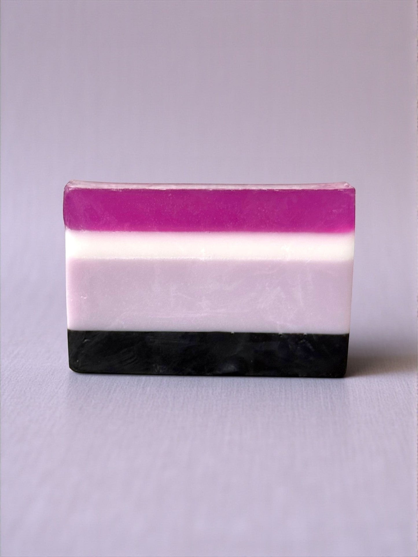Harry’s Mama’s Faves: Lotions & Potions handmade sandalwood patchouli bar soap with purple, white, and black layers.