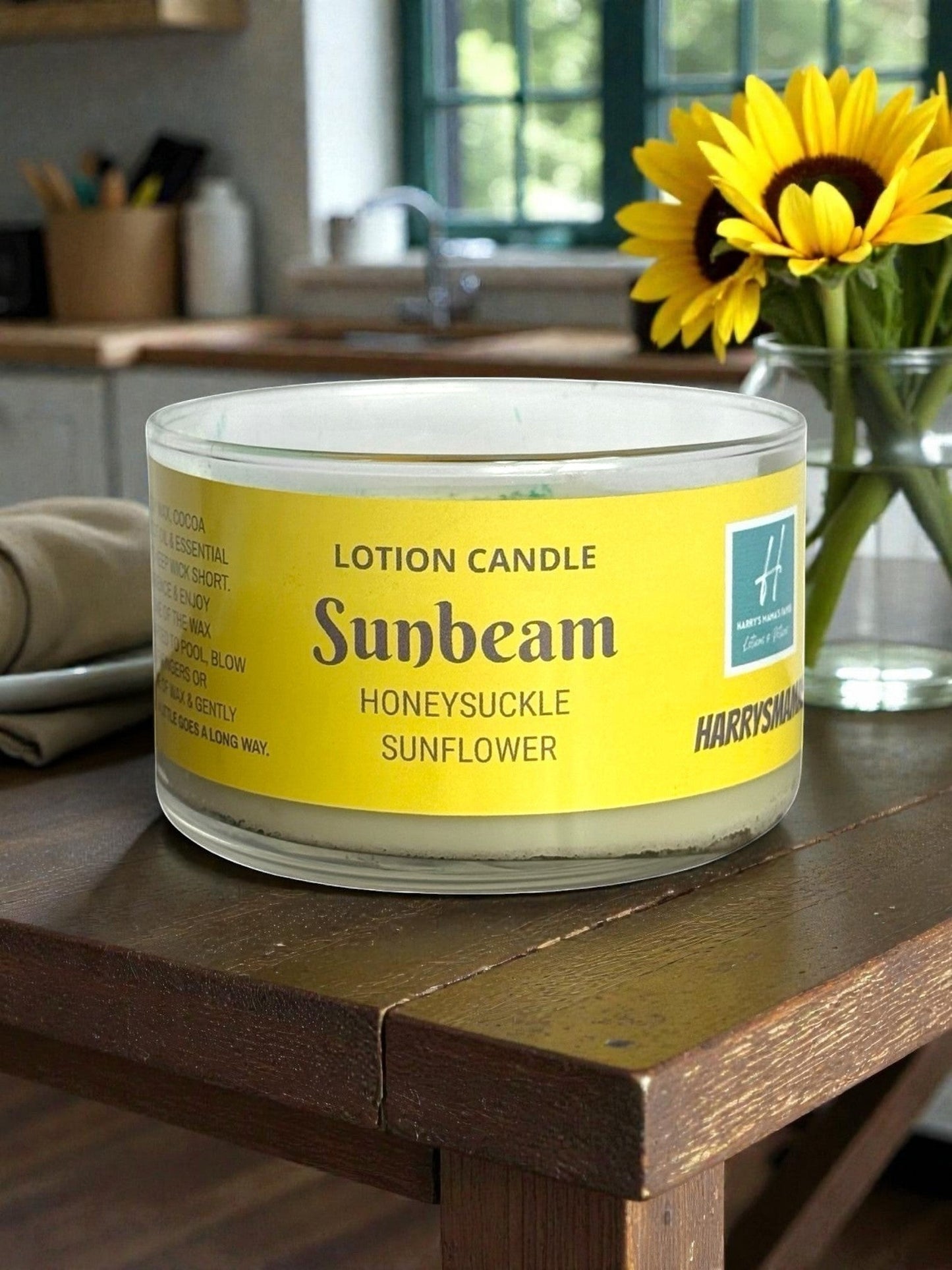 Harry’s Mama’s Faves: Lotions & Potions Sunbeam lotion candle with honeysuckle and sunflower scent on a wooden table.