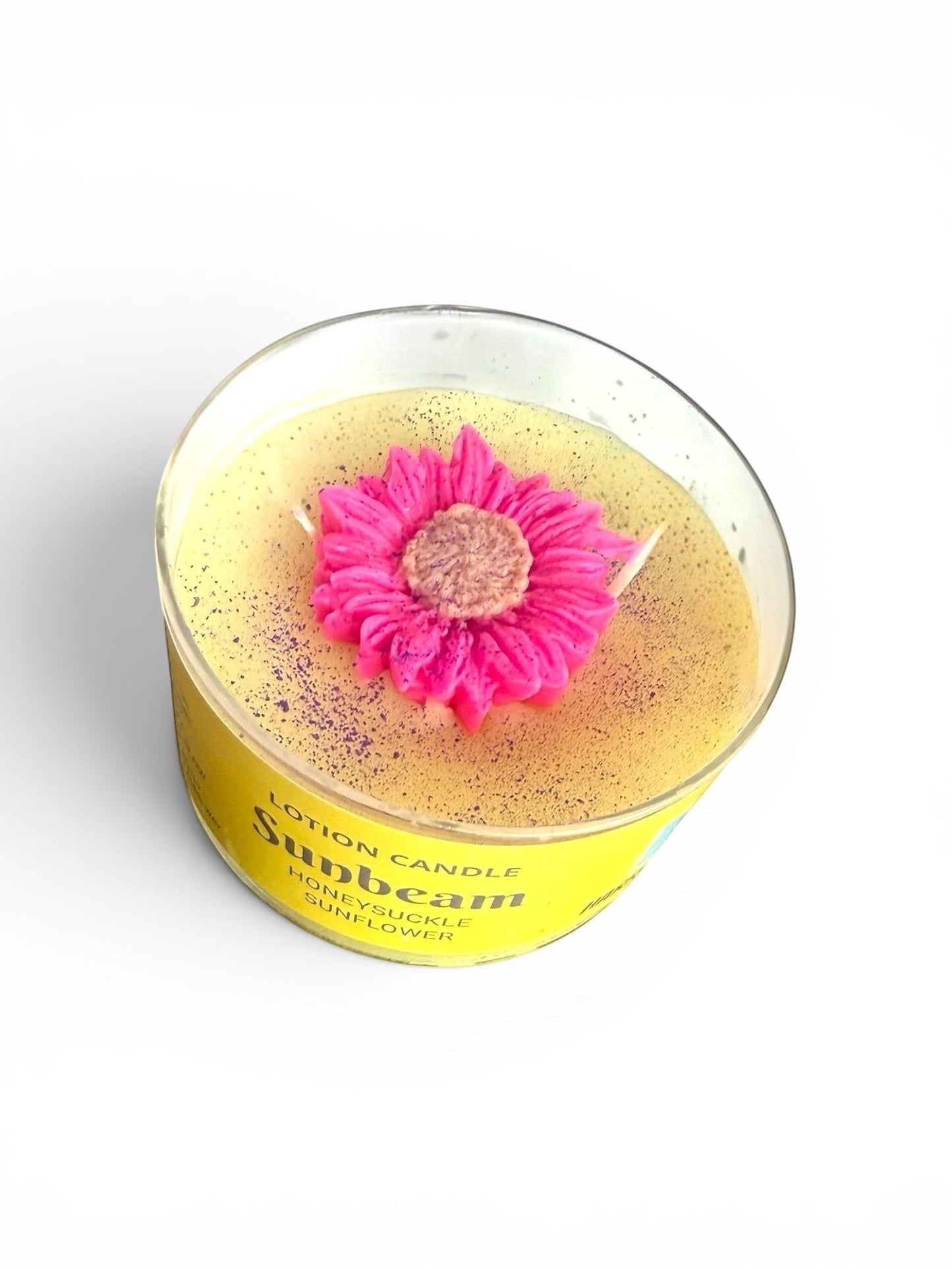 Harry’s Mama’s Faves: Lotions & Potions Sunbeam lotion candle with a decorative pink flower topper in a yellow jar.