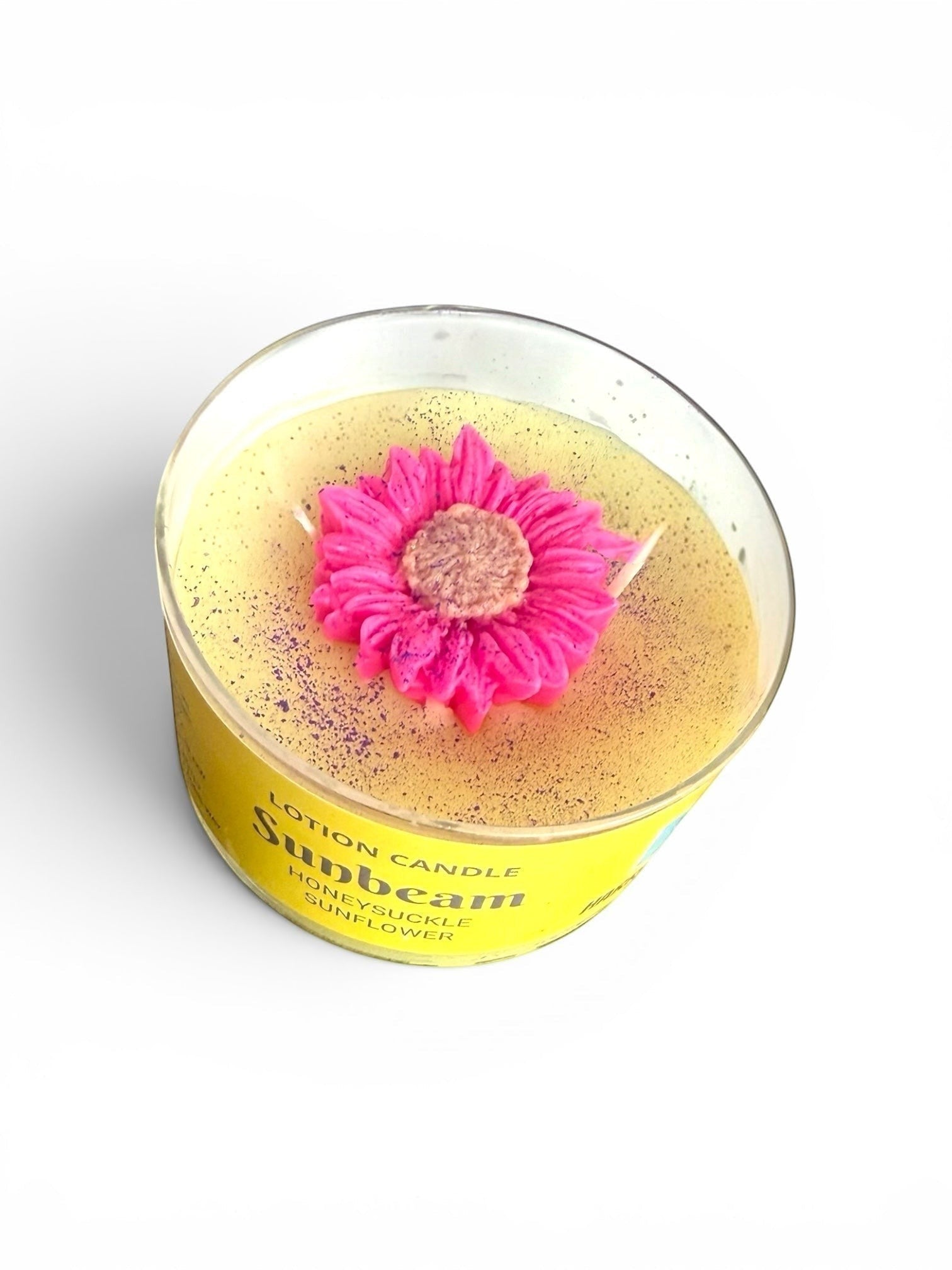 Harry’s Mama’s Faves: Lotions & Potions Sunbeam lotion candle with a decorative pink flower topper in a yellow jar.