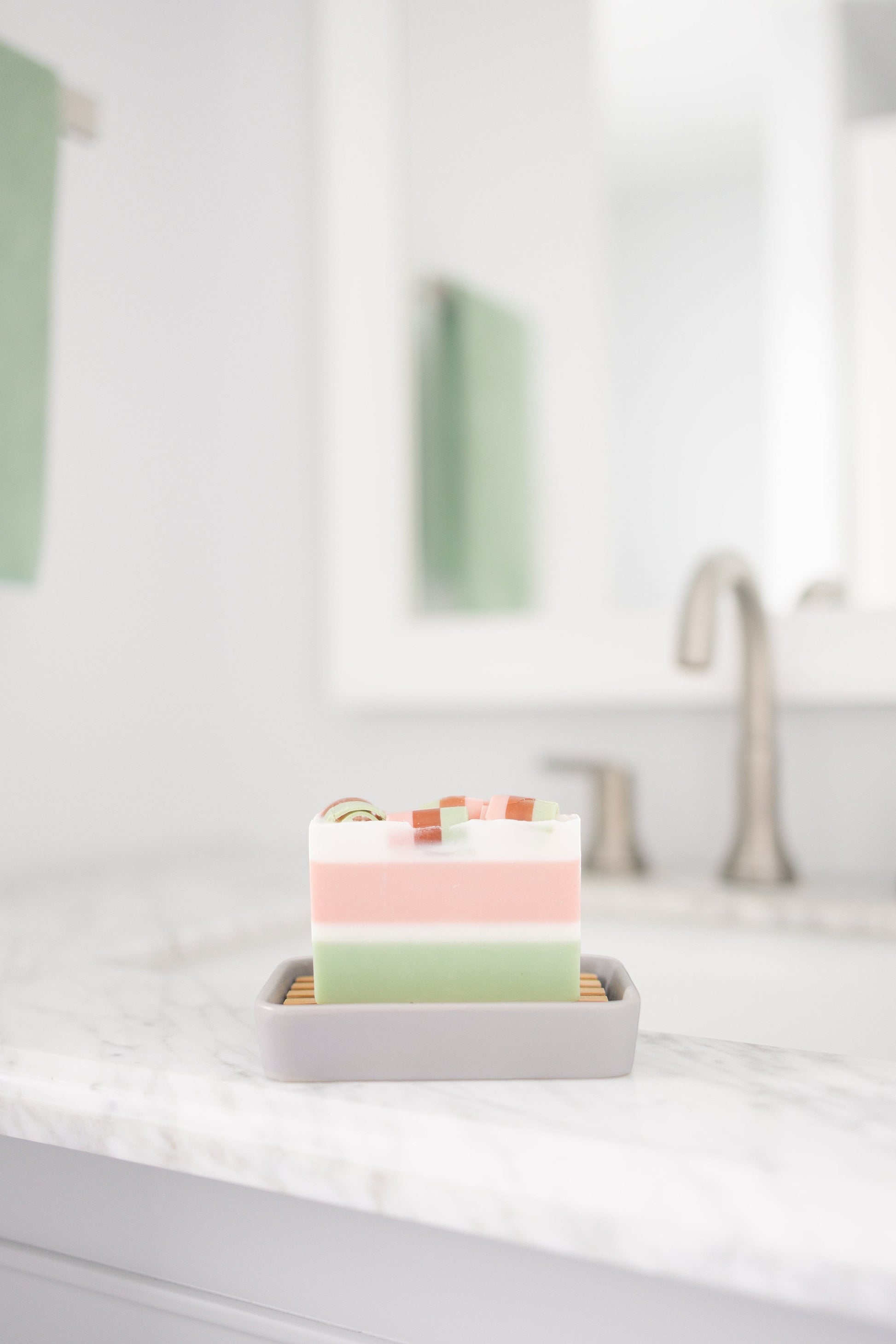 Harry’s Mama’s Faves: Lotions & Potions sunflower honey calendula artisan bar soap on a grey dish in a bathroom.